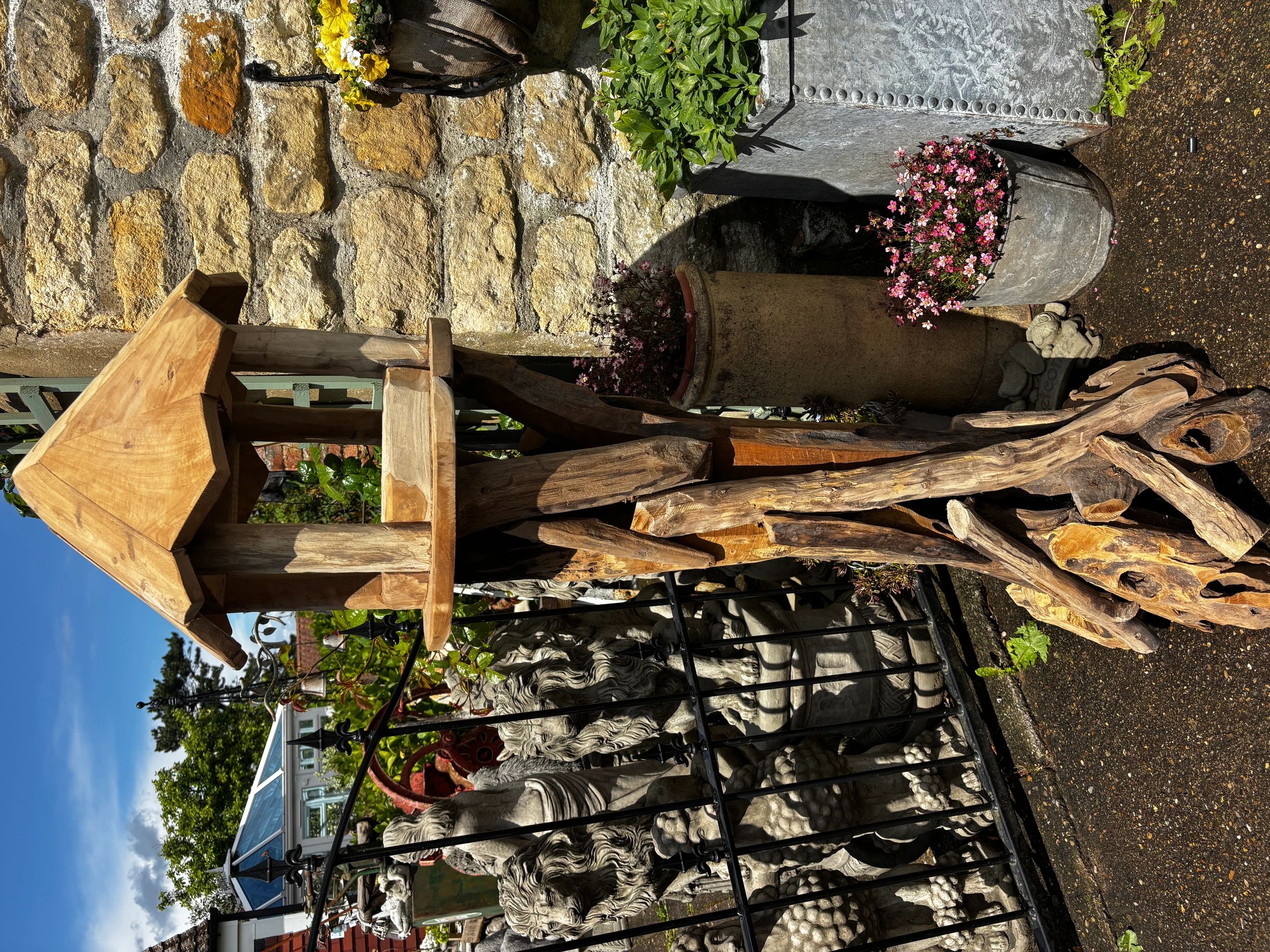Rustic wooden birdhouse with natural wood base.