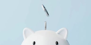 light blue background, white piggy bank coins falling in