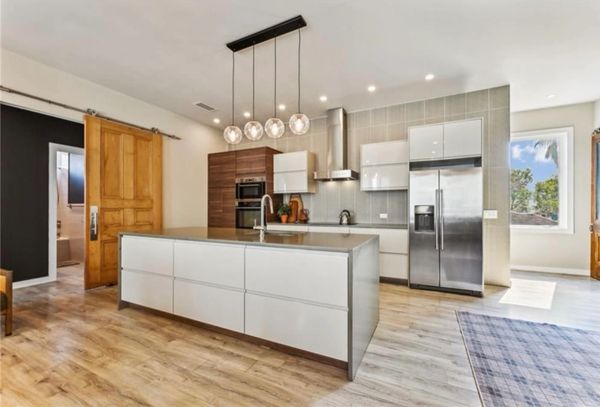 Modern kitchen with wooden accents and stainless steel appliances.