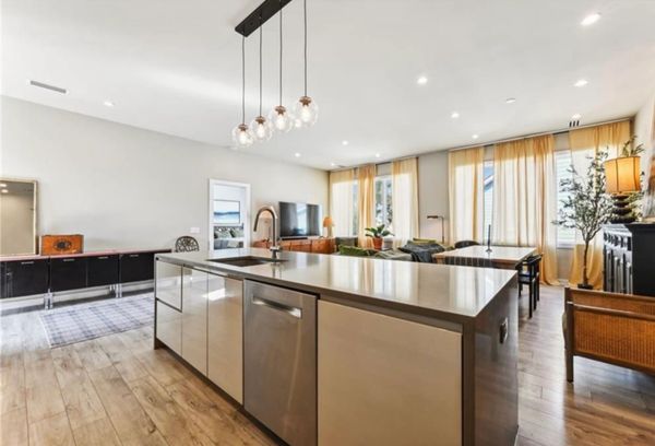 Modern open kitchen with a large island and warm lighting.