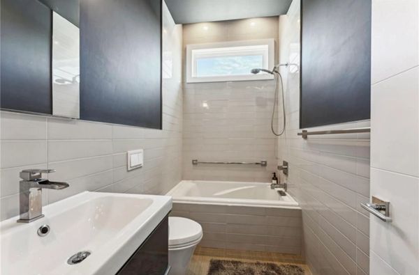 Modern bathroom with bathtub, shower, and sleek fixtures.