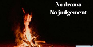 A campfire symbolizes warmth and unity, with messages of openness and no judgment.
