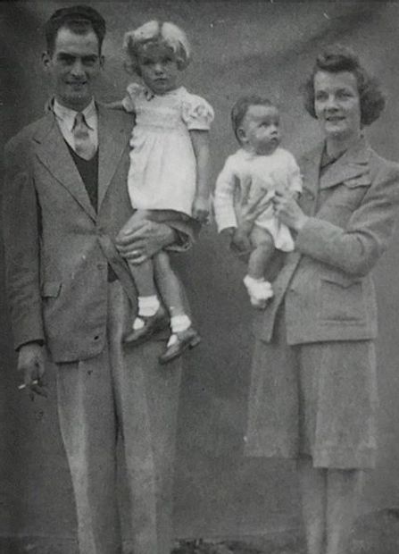 Jean and her sister being carried by her parents