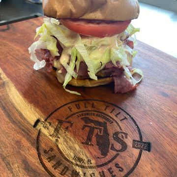 The Rock Crispy Breaded Chicken Fillets, Corned Beef, Lettuce, Tomato, Reubie Mayo, FTS Cheese Sauce, Toasted Brioche Bun