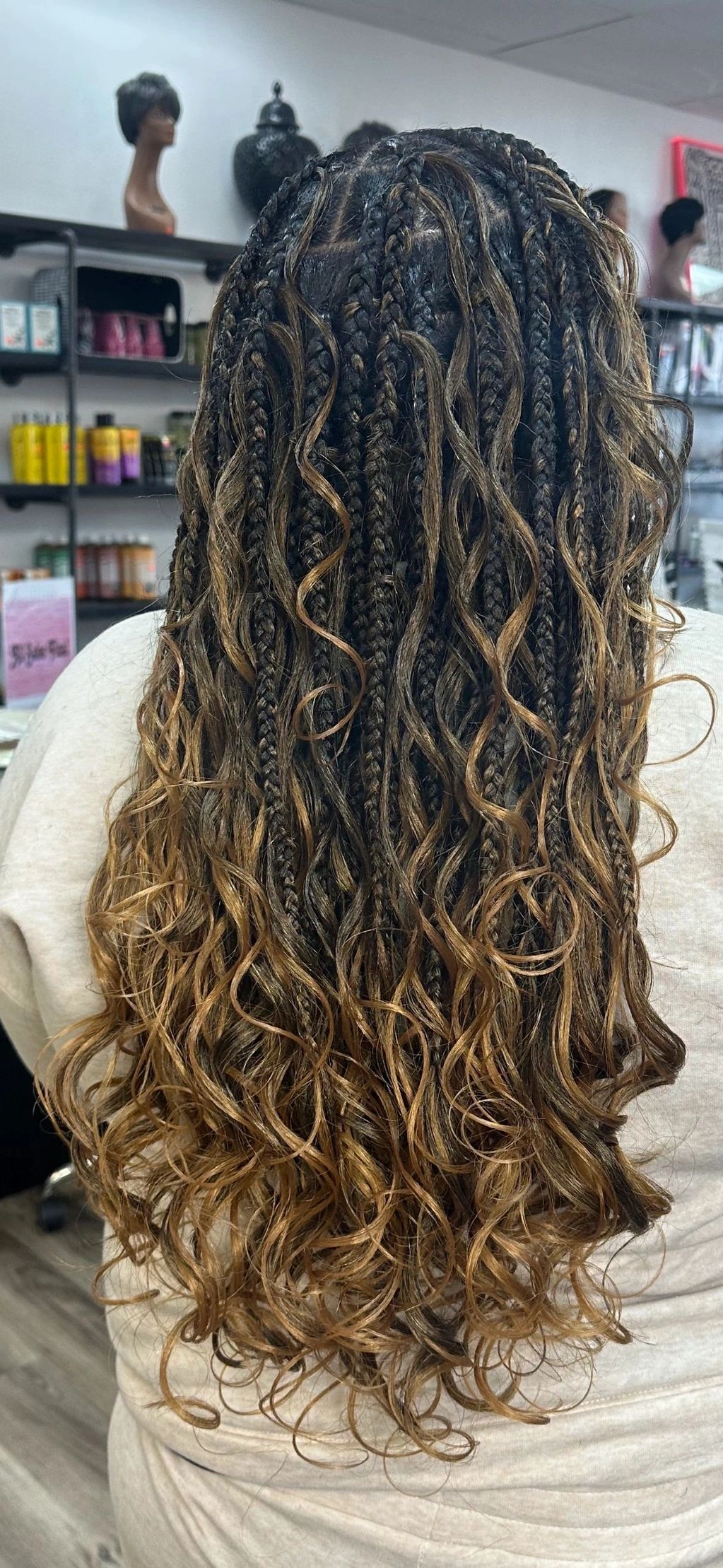 Knotless Braids with loose curls and highlights.