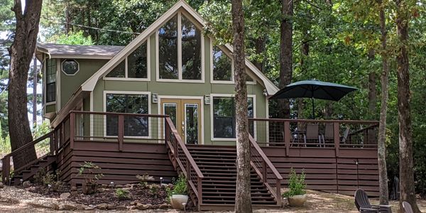 Clancy's Chalet is a lakefront cottage surrounded by trees.