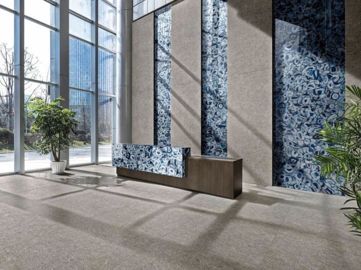 Modern lobby with natural light and blue patterned accents.