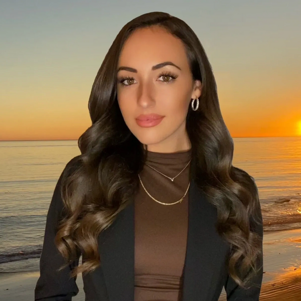 Cat McCann Orange County Realtor Headshot by beach with sunset