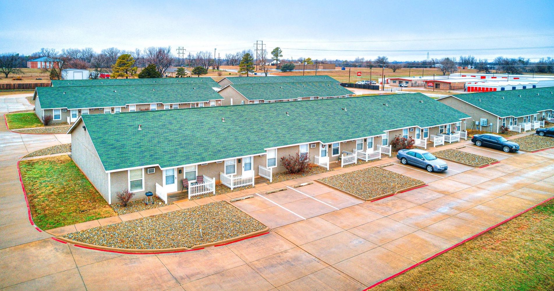 Aerial view of Cedar Creek garden cottages with green roofs and white porch railings