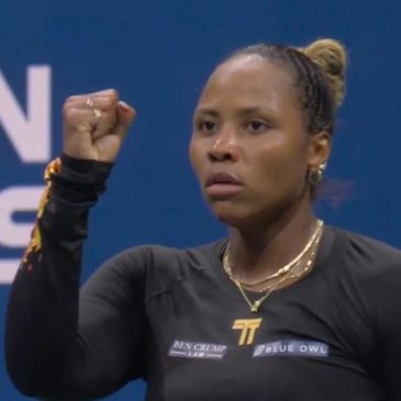 Tennis player raising fist in determination.