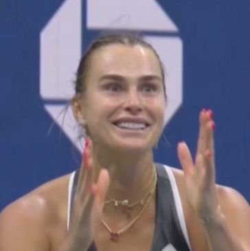 Woman cheering with excitement during a sports event.