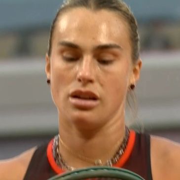 Tennis player in action, focused expression.