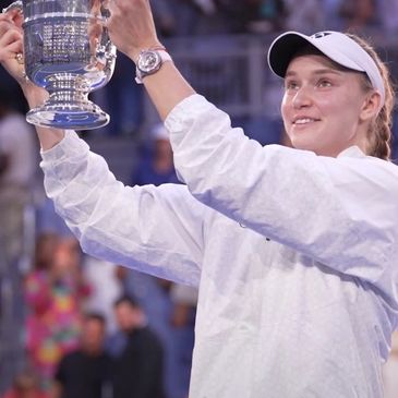 Tennis player holding a trophy.