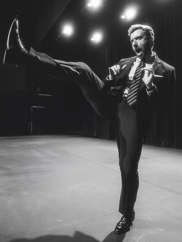 Man in a suit kicking energetically on stage.