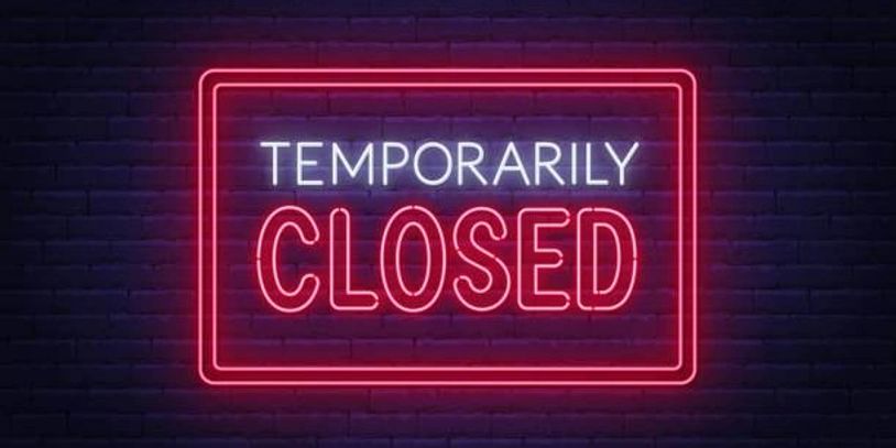 Neon sign reading "Temporarily Closed".