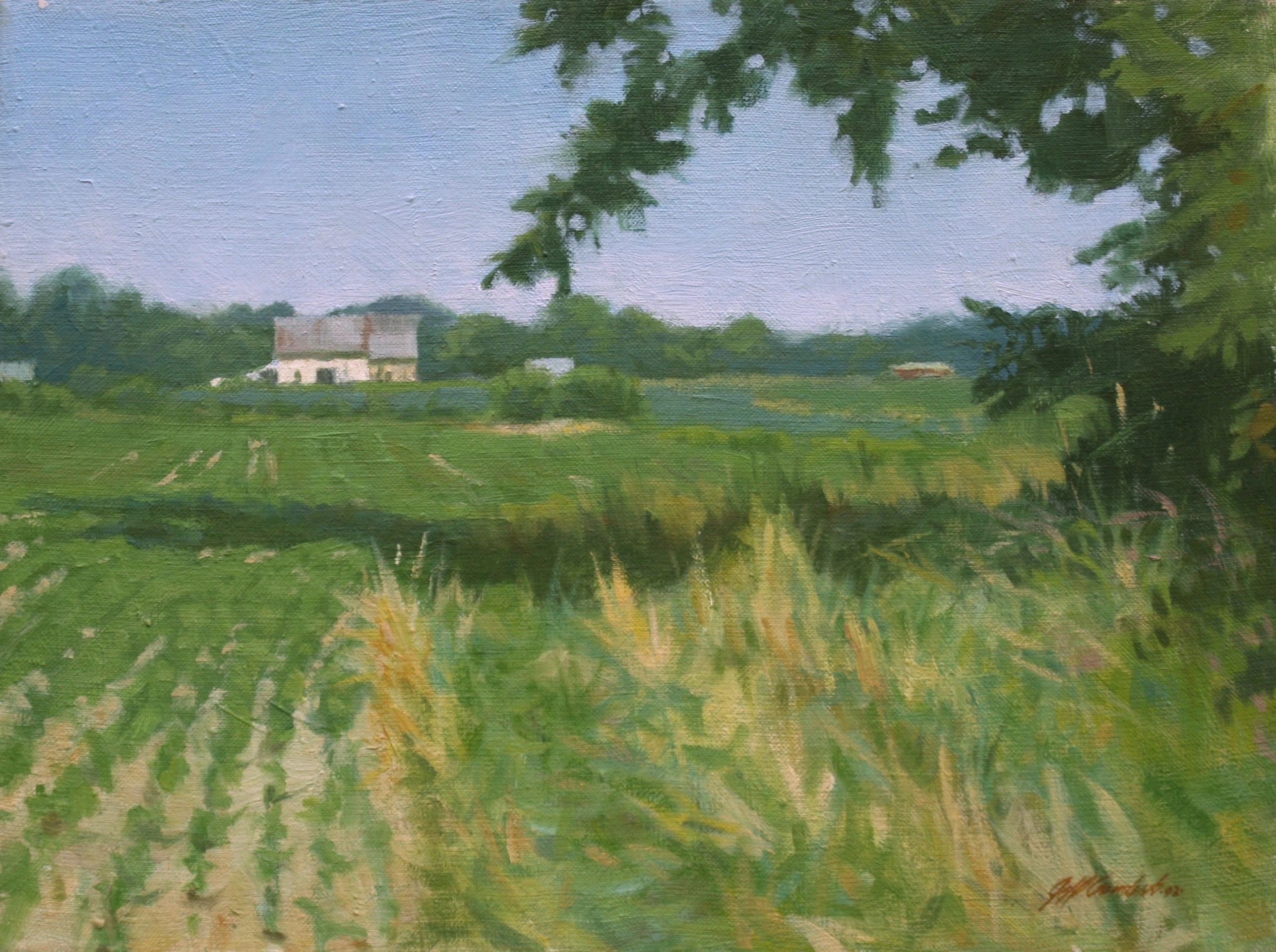 A peaceful rural landscape with a farmhouse and green fields under a clear sky.
