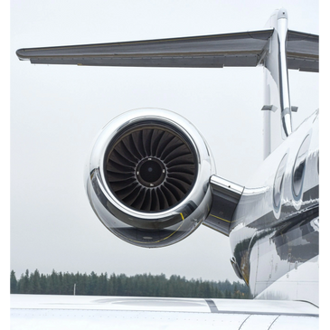 Close-up view of a jet engine mounted on an aircraft wing.