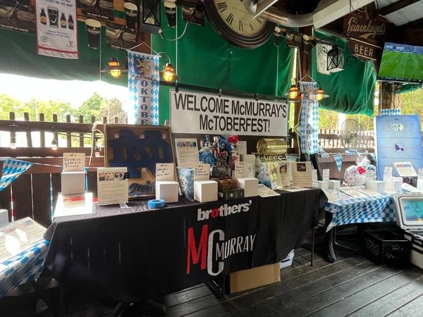 Oktoberfest celebration booth with decorations and raffle prizes.