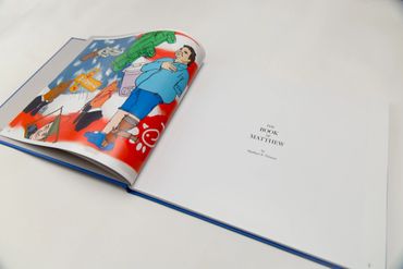 Open book showing an illustrated page and a title page.