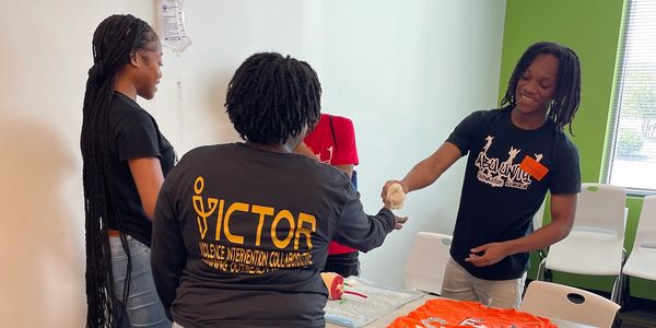 Youth group interacting and sharing in a room.