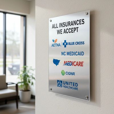 Sign listing accepted insurance providers at a medical office.
