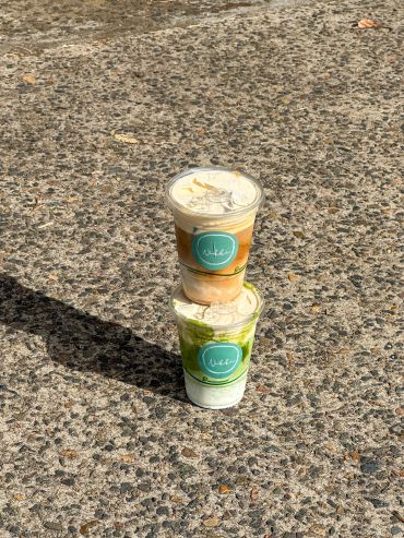 Two stacked drinks on a rough surface.