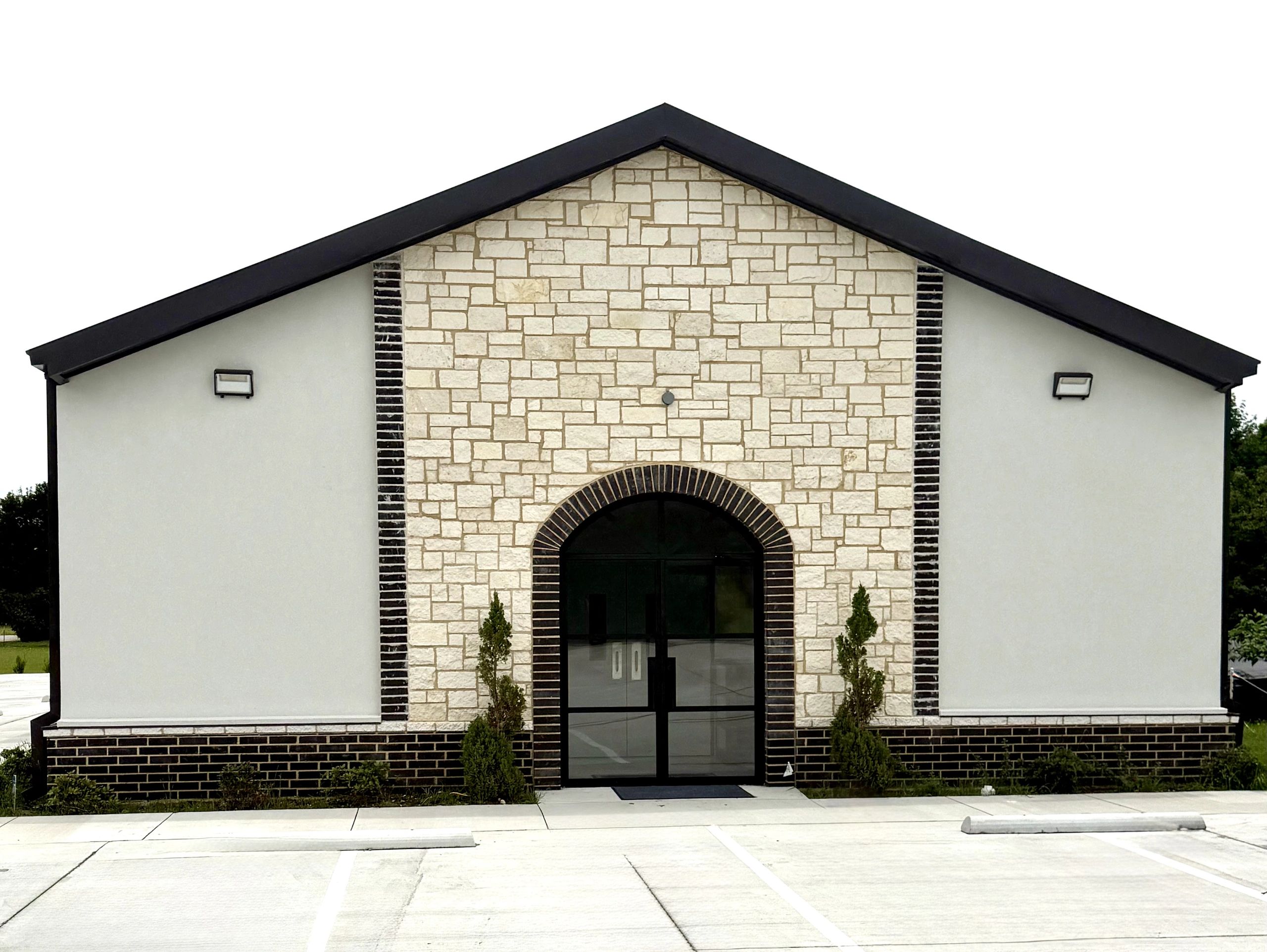 Modern building entrance with stone and brick facade.
