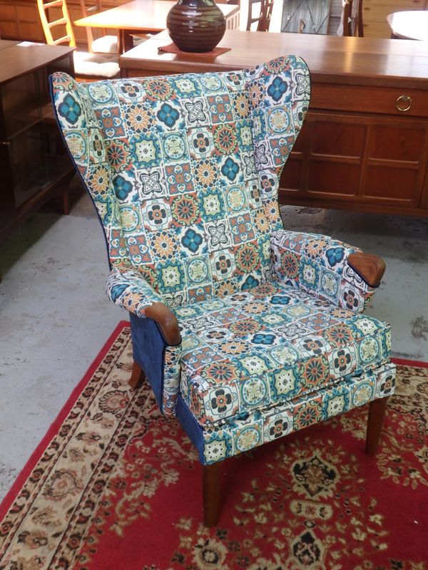 A closeup look at a chair with other furniture behind.