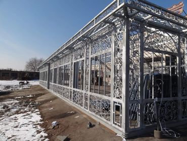 Huge Victorian style glass greenhouse during construction.