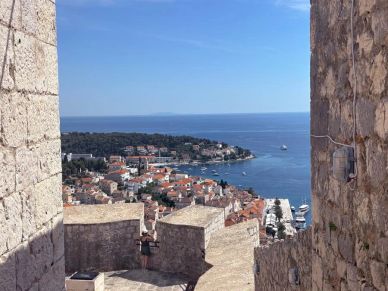 View of a coastal town through stone walls.