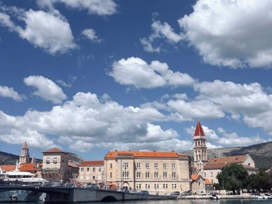Historic buildings under a blue sky with clouds.