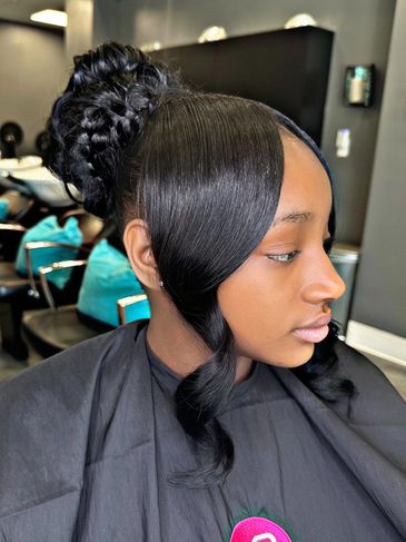 Elegant updo hairstyle with smooth front waves and braided bun.