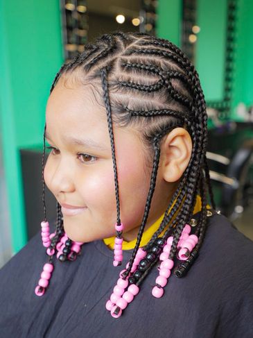Young girl with cornrow braids adorned with pink beads.