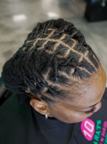Intricately styled dreadlocks with a neat, crisscross pattern.