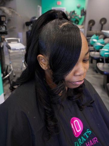 Woman with styled black hair in a salon setting.