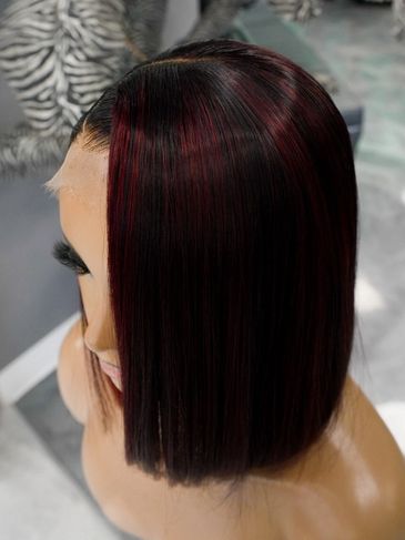 Sleek, straight bob hairstyle with subtle red highlights.