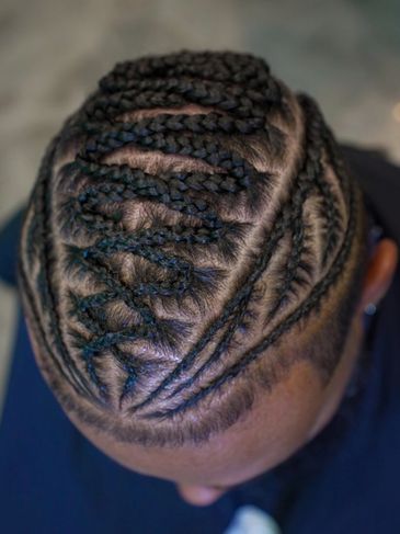 Intricate braided hairstyle with unique zigzag patterns on top.