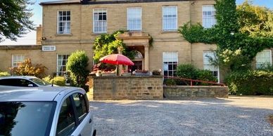 A modern-day picture of Springfield House Retirement Home bathed in  sunshine