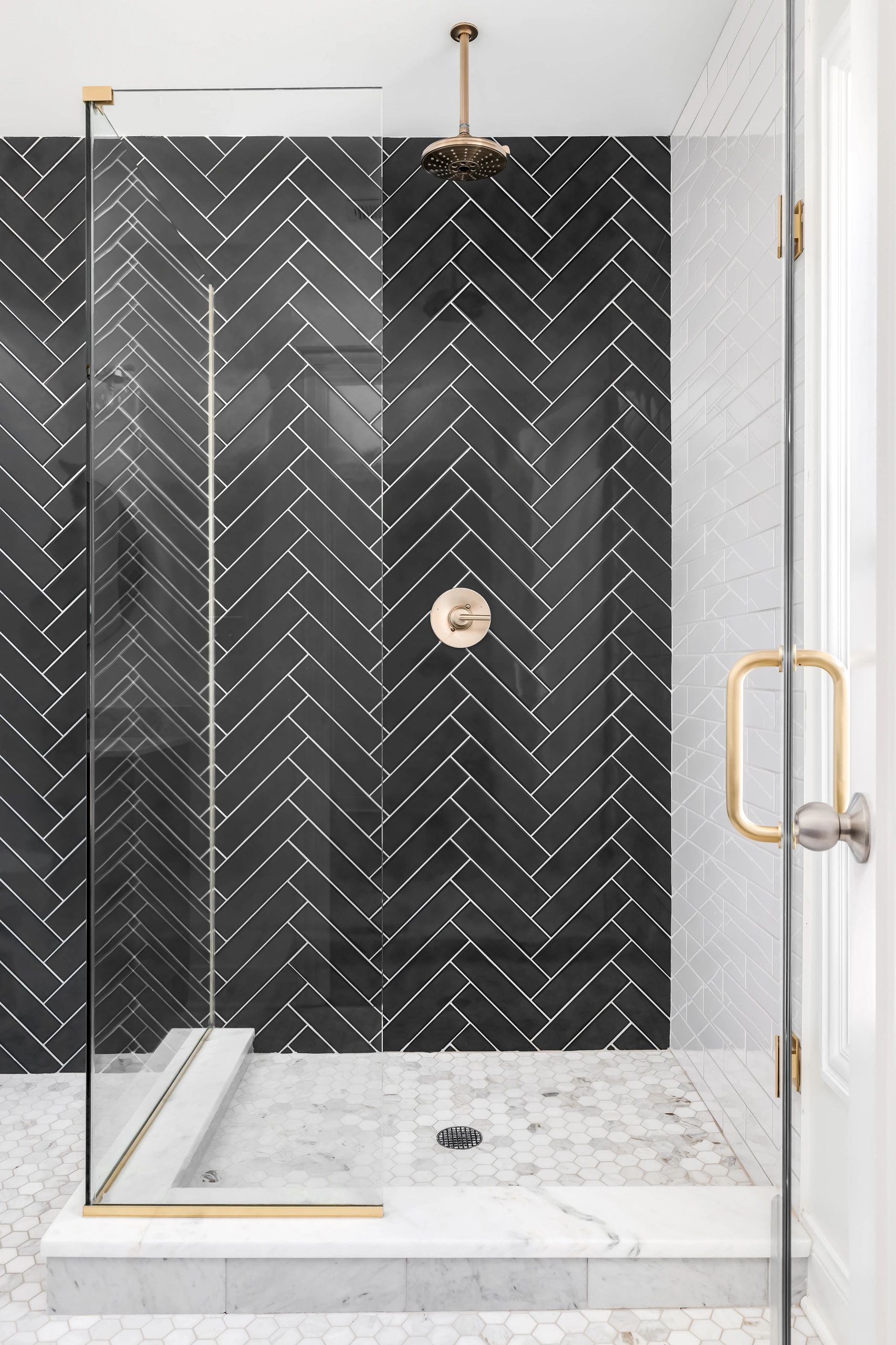 white subway tile shower with black subway herringbone feature wall carrara marble hex mosaic floor