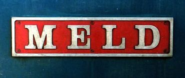Red sign with the word MELD in white letters.