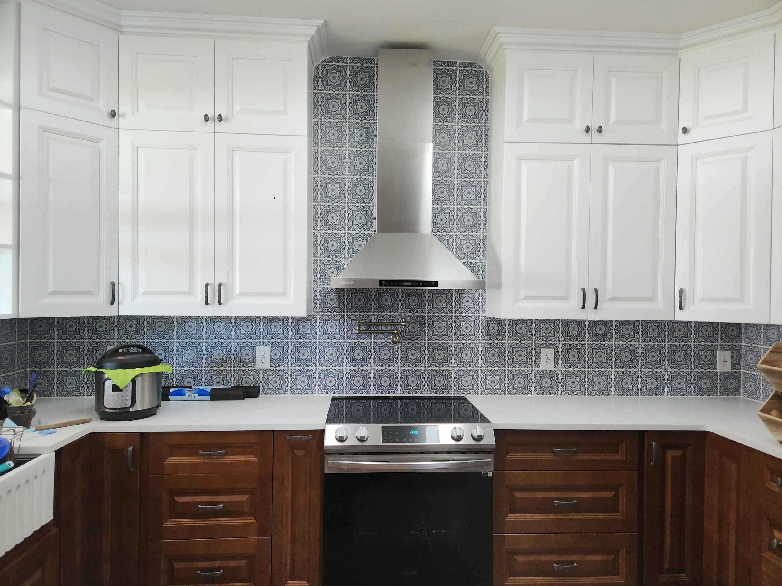This kitchen features classic white raised-panel upper cabinets paired with dark wood lower cabinets