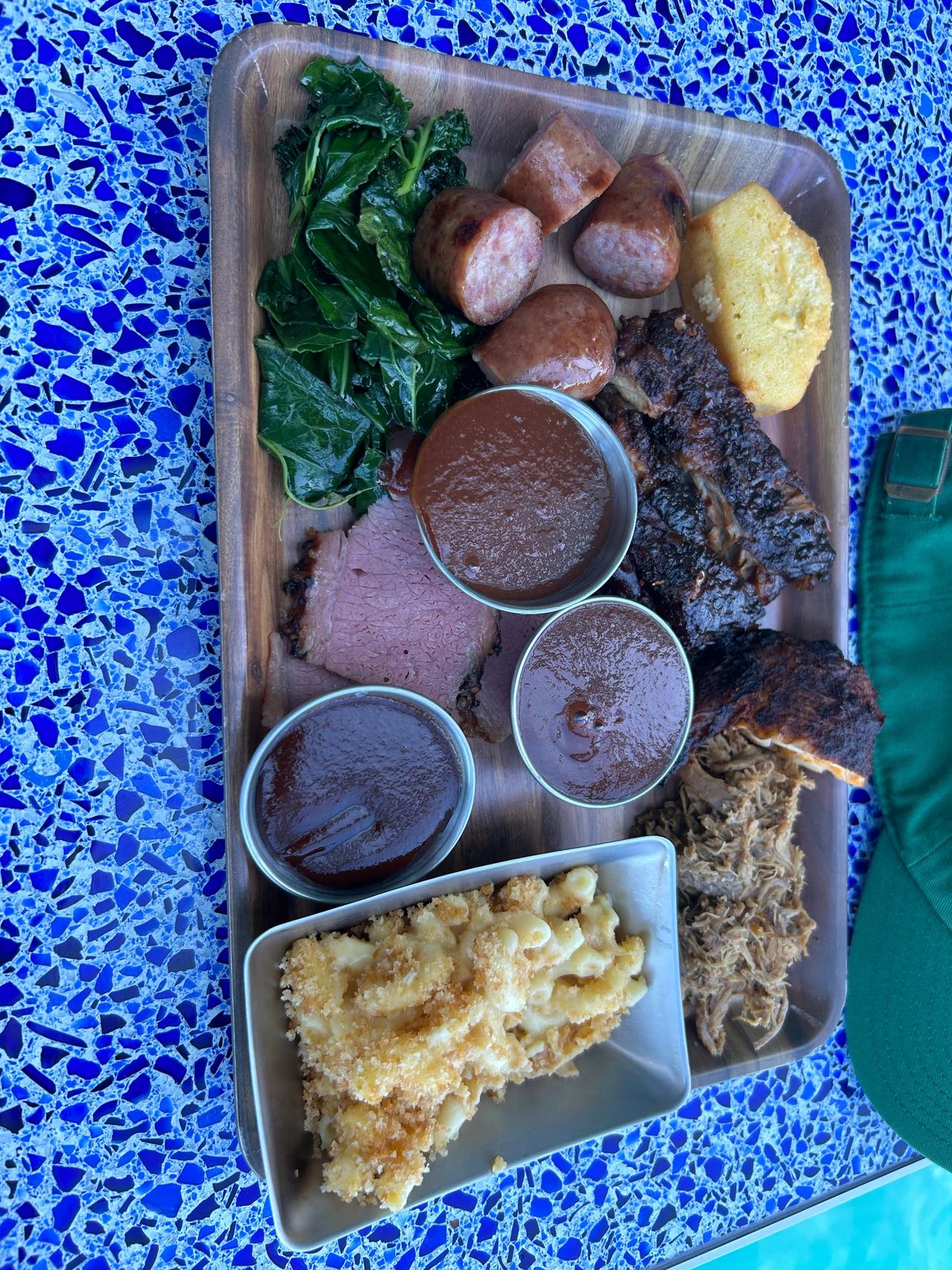 The barbeque combo platter, available from Mickey’s Smokestack on the Disney Wish offers a little bit of everything to eat, from great smoked meats to delicious sides.