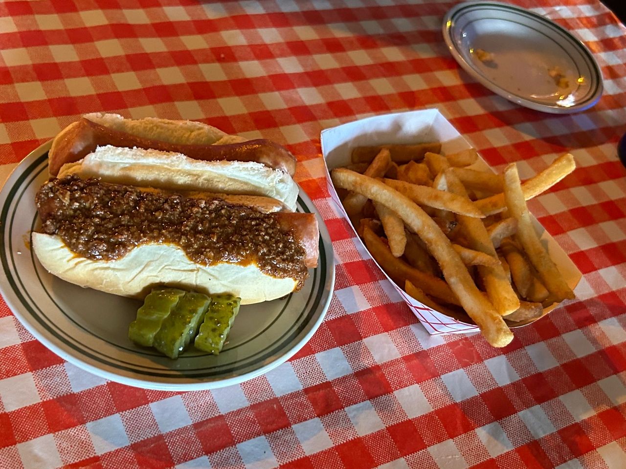 The famous Tony Packo hot dog. Made to your specifications, this one features one plain and one with their special chili sauce. The hot dog platter comes with a cup of chili, fries and some spicy pickles. The famous Tony Packo hot dog. Made to your specifications, this one features one plain and one with their special chili sauce. The hot dog platter comes with a cup of chili, fries and some spicy pickles.