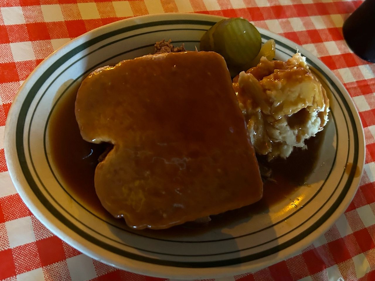 Tony Packo's roast beef sandwich, which is really a beef Manhattan is served over their hand prepared mashed potatoes along with their spicy pickles. Tony Packo's roast beef sandwich, which is really a beef Manhattan is served over their hand prepared mashed potatoes along with their spicy pickles.