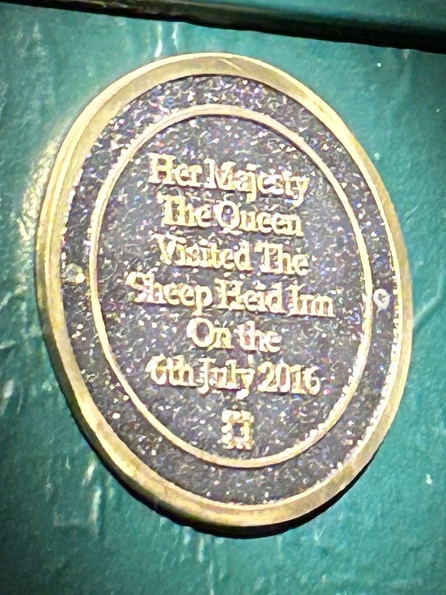 Proudly displayed in the dining area, this plaque honors the late Queen Elizabeth's visit in 2016.