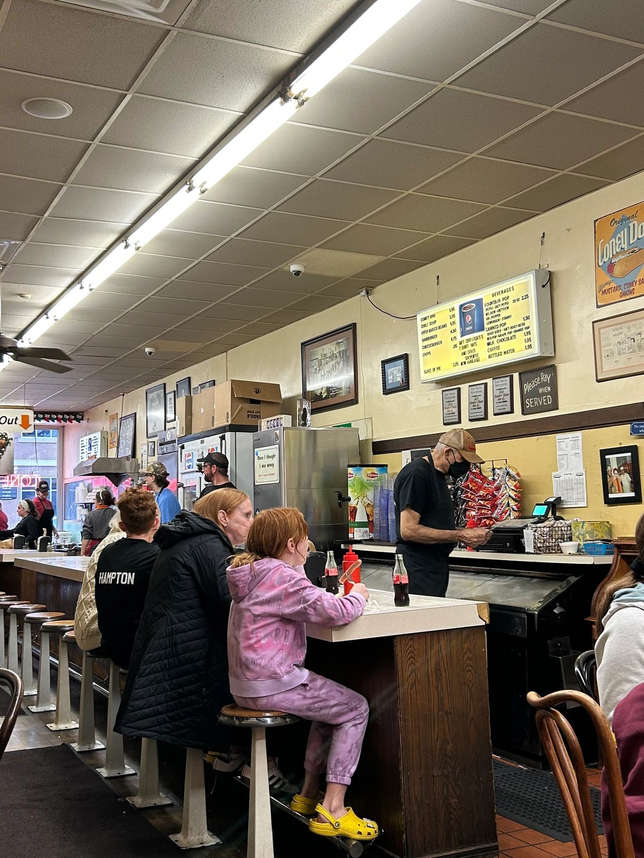 Enjoy your coney dog at the counter or at one of the tables at Coney Island in downtown Fort Wayne. The menu, located behind the counter, is largely unchanged over the past 100+ years.