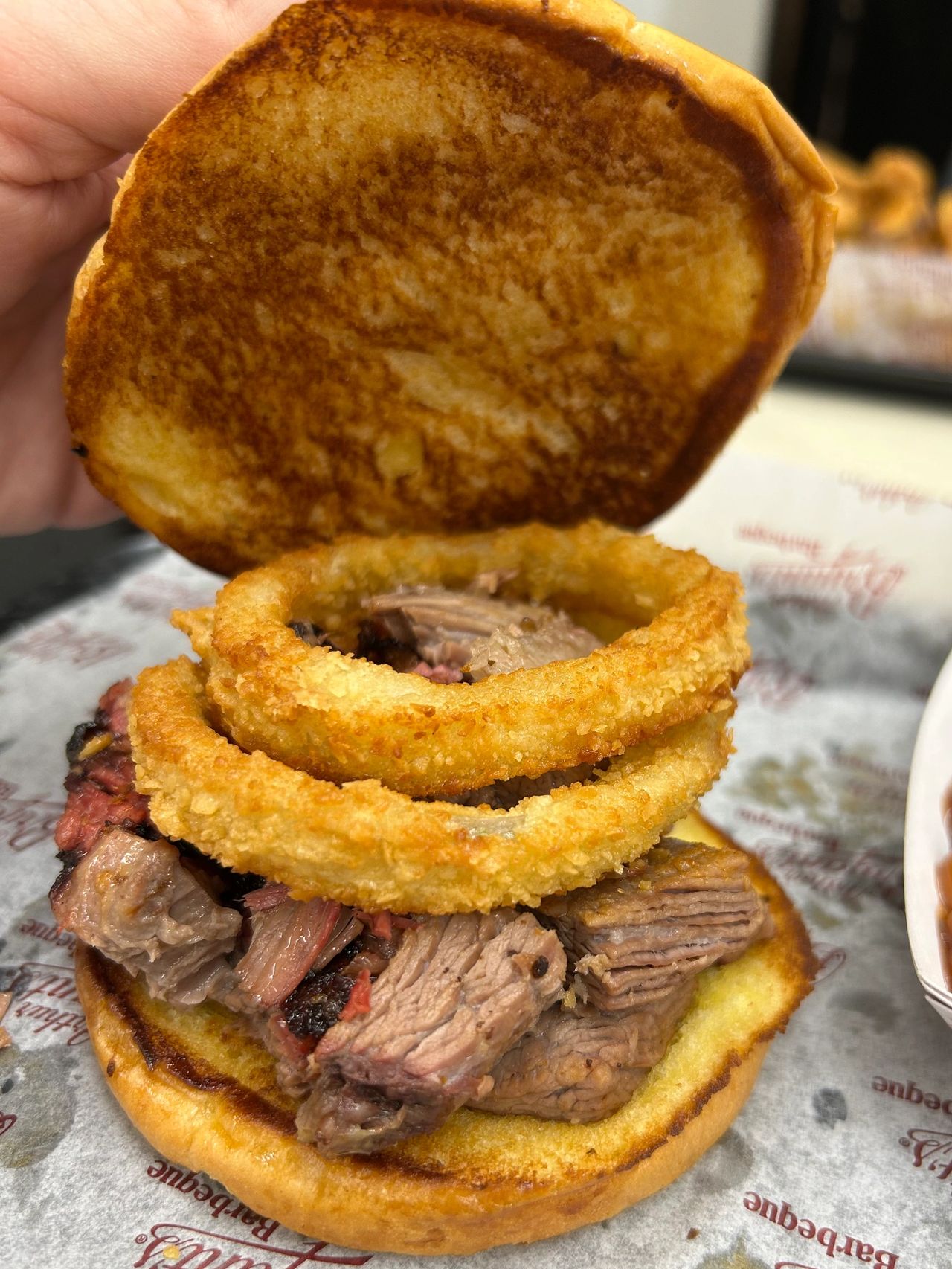 The 3B special, a burnt ends sandwich topped with an onion ring is one of the specialty sandwiches at Arthur Bryant's Barbeque in Kansas City.