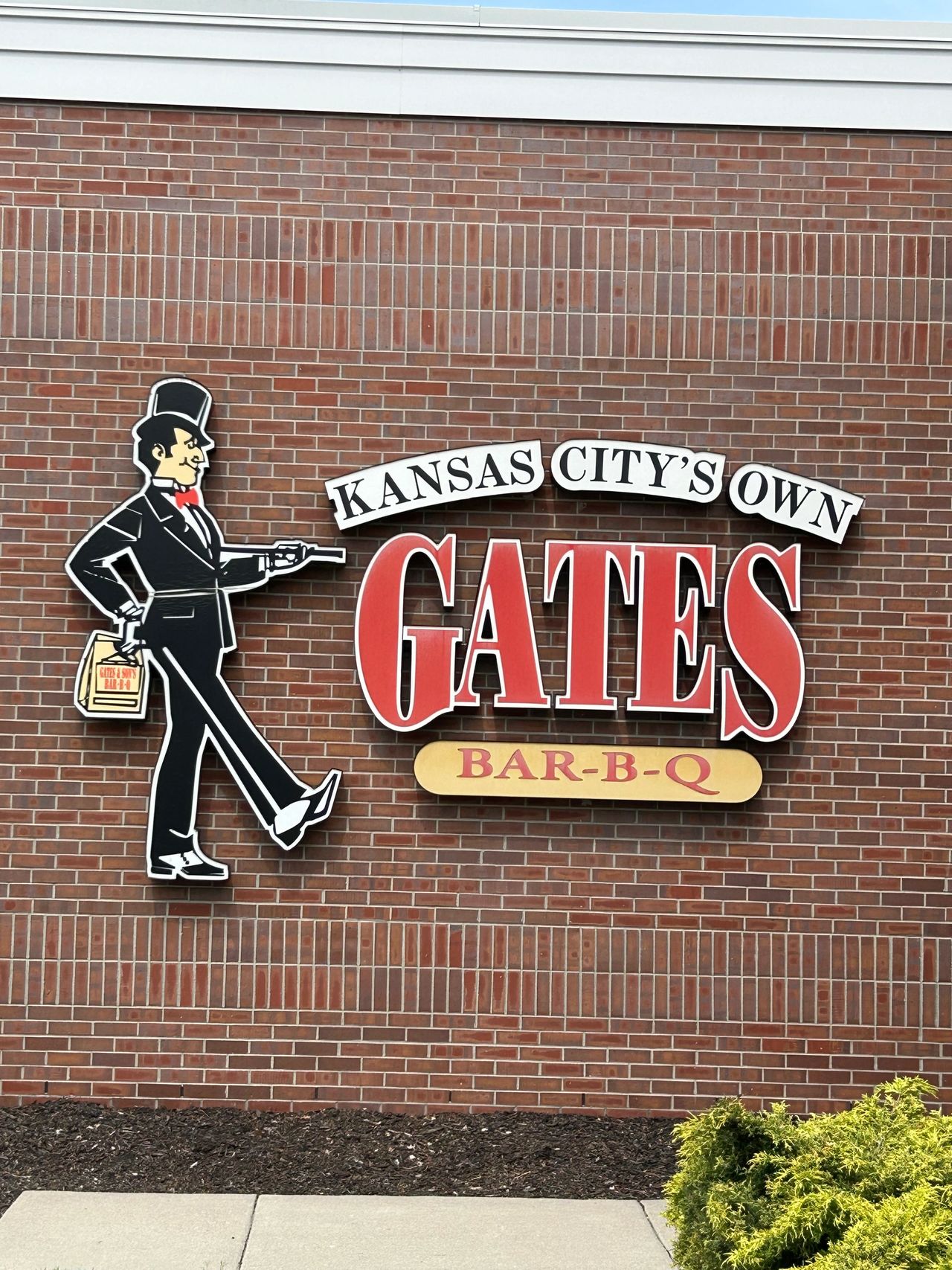 The struttin’ man logo of Gates Bar-B-Q, a mainstay in Kansas City all five locations .