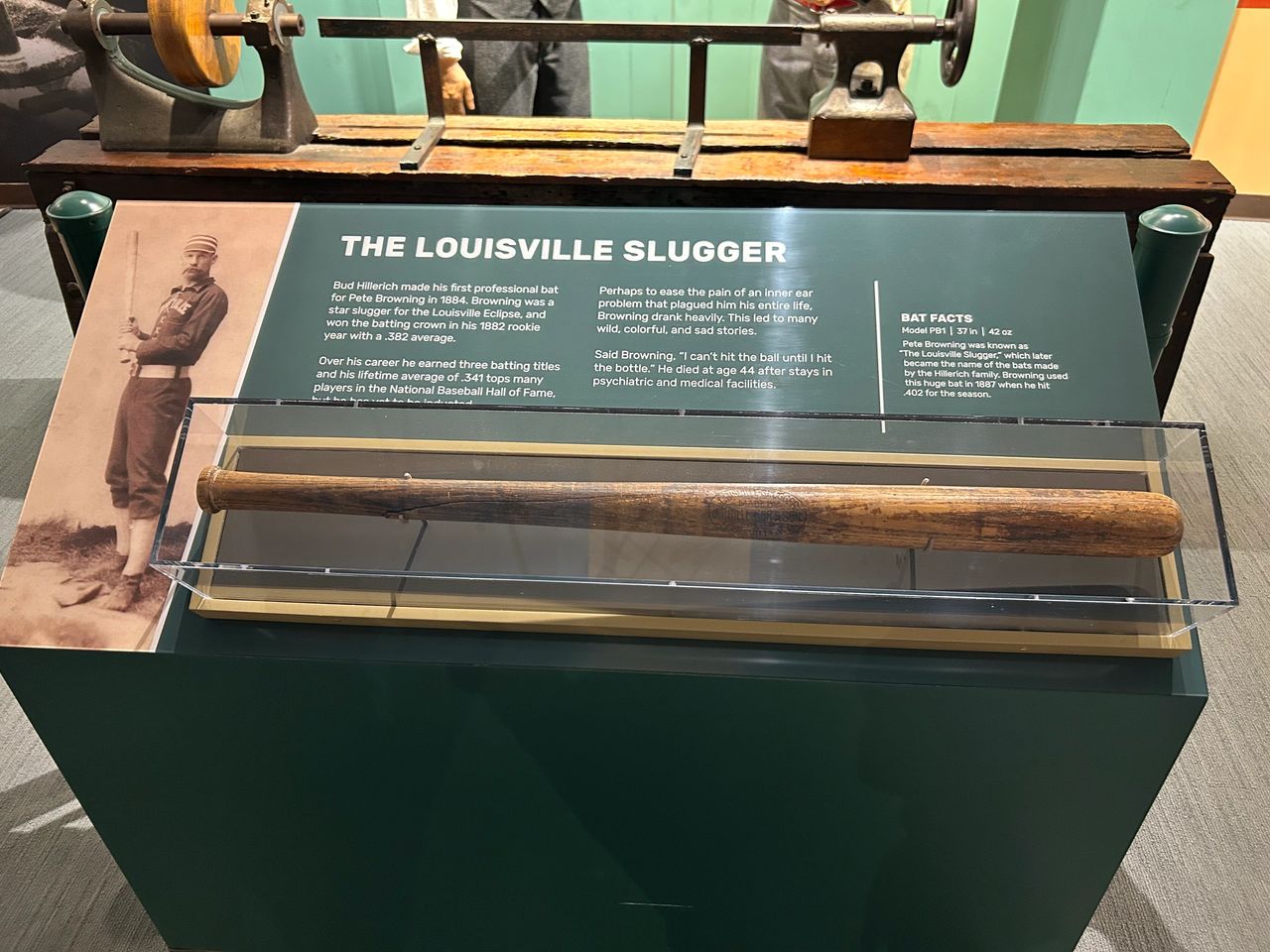 The original 1884 Louisville Slugger bat made for Pete Browning, displayed in a glass exhibit case at the Louisville Slugger Museum.