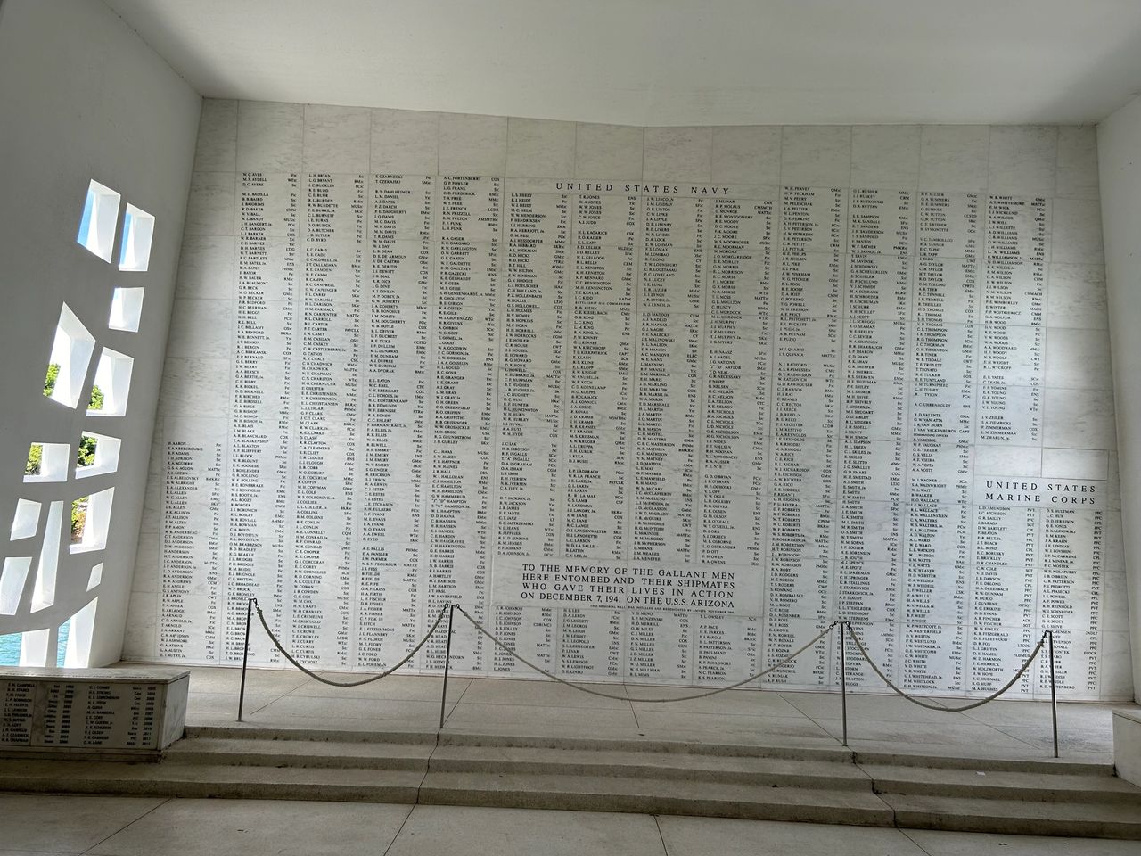Inside the floating USS Arizona Memorial is a somber memorial. The marble wall lists all the names of those lost during the attack.